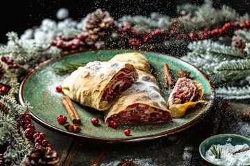 Strudel with a cherry. winter dessert strudel with cherry, cranberries and walnut. Food recipe background. Close up