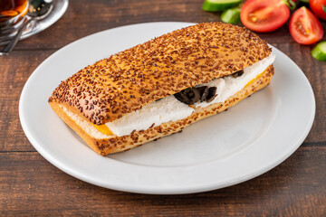 Olive and cheese sandwich with Turkish tea on wooden table