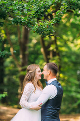 profile of the newlyweds in each other's arms on the background