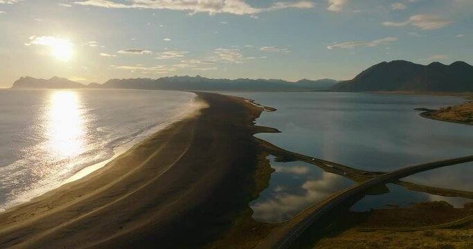 aerial view over Hvalnes Nature Reserve black beach during sunset over the atlantic ocean