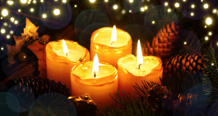 Four Advent candles with decorations isolated on lights background.
