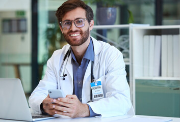 Doctor, desk and phone with smile for texting, communication or chatting and good connection at...
