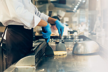Hand of man take cooking of meat with vegetable grill, Chef cooking wagyu beef in Japanese teppanyaki restaurant
