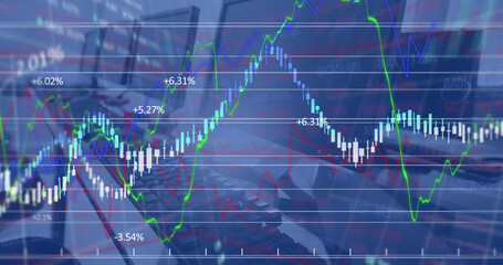 Image of financial data processing against close up of desks at office