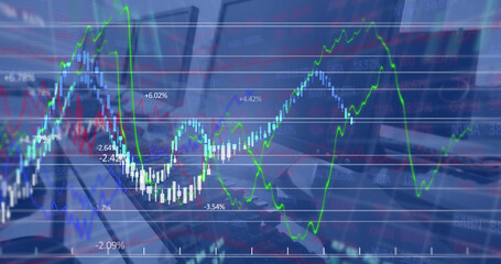 Image of financial data processing against close up of desks at office