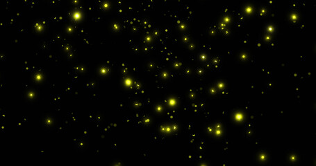 Fototapeta na wymiar Image of glowing yellow spots falling on black background