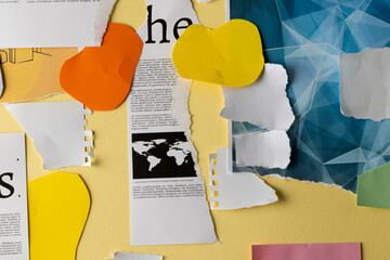 Ripped up pieces of notebooks, newspaper and coloured paper with copyspace on yellow background