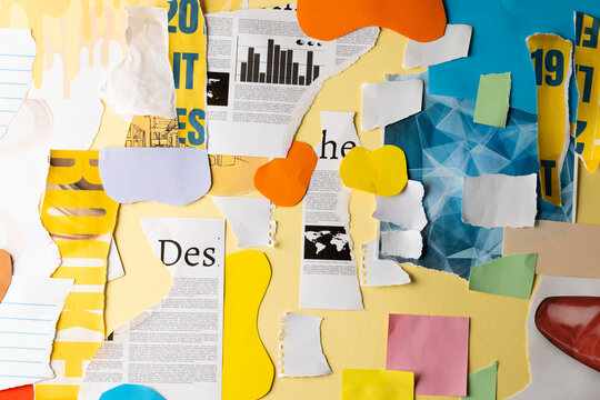 Ripped up pieces of notebooks, newspaper and coloured paper with copyspace on yellow background