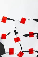  Ripped up pieces of white paper stuck together with red tape with copy space on black background © vectorfusionart