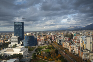 Fototapeta na wymiar Tirana from above. Wide angle aerial view with the city center of Tirana city during a cloudy day in Albania, 2022.