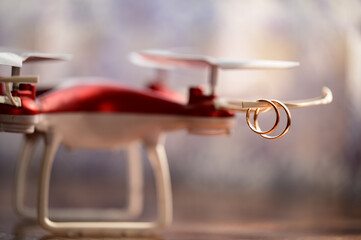 Two rings hang on the propellers of the drone.