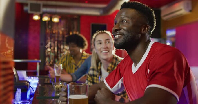 Video Of Diverse Group Of Happy Friends Drinking And Watching Sports Game At A Bar