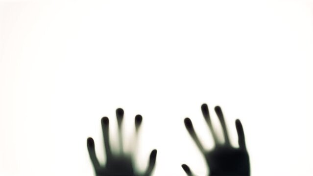 shadows of hands hit the glass. Thriller, horror, violence concept