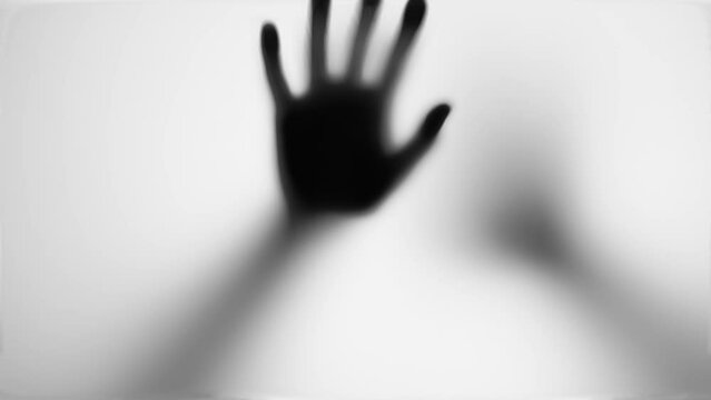 Hand scratching glass, monster behind door, evil ghost or walking dead, zombie. Thriller, horror concept