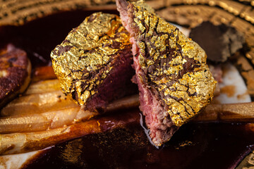 Black Angus 24 carat gold steak. Beef tenderloin, foie gras, fresh black truffle, white asparagus, port wine sauce. Delicious food closeup served for lunch in modern gourmet cuisine restaurant - 552313781