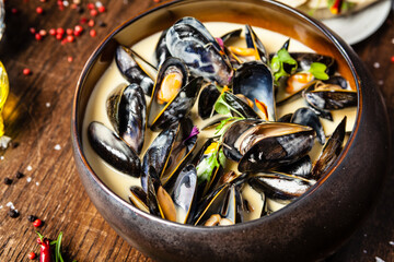 Blue mussels in cream wine sauce. Delicious healthy Italian traditional food closeup served for lunch in modern gourmet cuisine restaurant