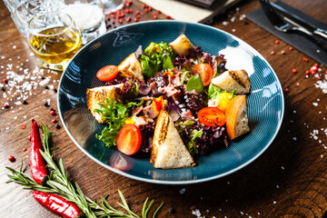 Warm chicken liver salad with port wine-honey sauce. Carrot cream, bacon, cherry tomatoes, brioche. Delicious healthy traditional food closeup served for lunch in modern gourmet cuisine restaurant
