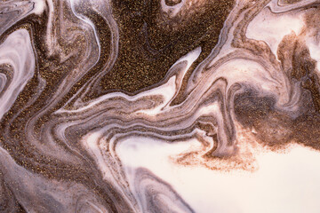 Shimmer liquid stripy background from liquid nail polishes,brown and milky colors.