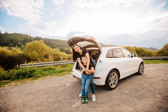 Road trip mith son. Woman with a child in summer clothes in the mountains. Couple of mother with her son on vacation. Single mom on vacation with his boy. Road trip with child	