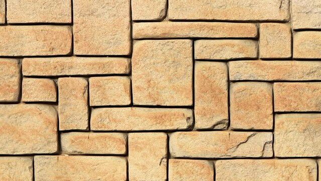 Masonry stone cladding wall texture seamless loop. Geometric shapes surface background.