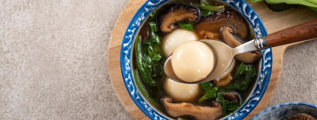 Eating big tangyuan yuanxiao with savory soup in Taiwan.