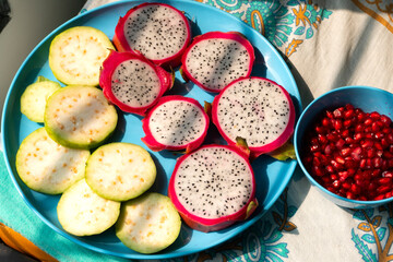 Pile of various types of fresh organic fruits (red berry strawberry, green apple, kiwi slice, orange and grapes fruit) isolated on wooden background. Healthy food boost immunity system concept.

