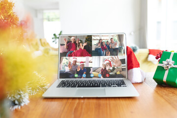 Diverse people having christmas video call on laptop screen