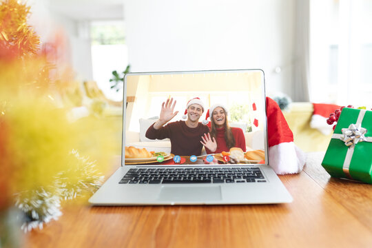 Caucasian couple having christmas video call on laptop screen