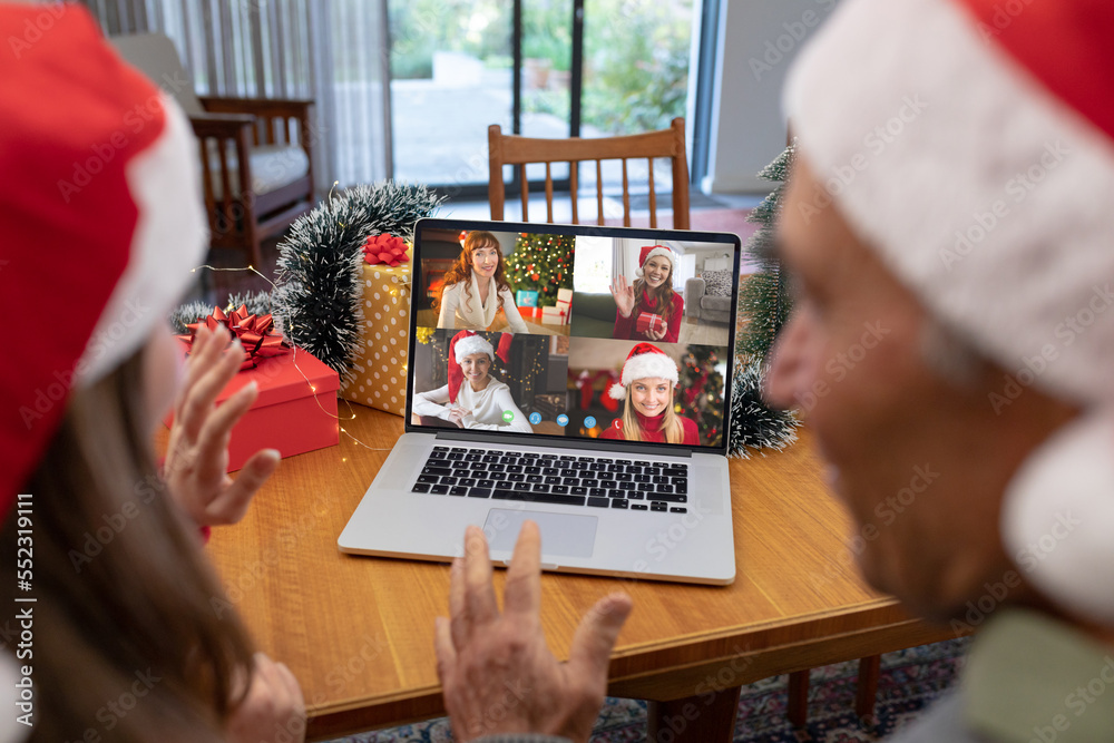 Sticker Caucasian father and daughter in santa hats on christmas laptop video call with caucasian friends