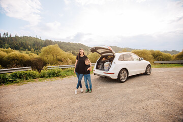 Road trip mith son. Woman with a child in summer clothes in the mountains. Couple of mother with her son on vacation. Single mom on vacation with his boy. Road trip with child	