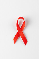 Vertical composition of red ribbon for hiv or aids awareness, on white background with copy space