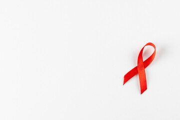 Composition of red ribbon on white background