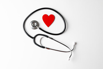 Composition of stethoscope and red heart on white background with copy space