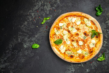 four cheese pizza, homemade italian pizza. Pizza on rustic black background. Traditional italian cuisine. place for text, top view