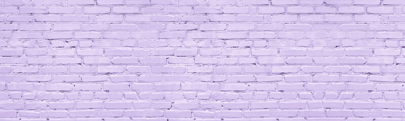 Pastel lavender color painted old brick wall wide texture. Light violet rough brickwork. Grunge...