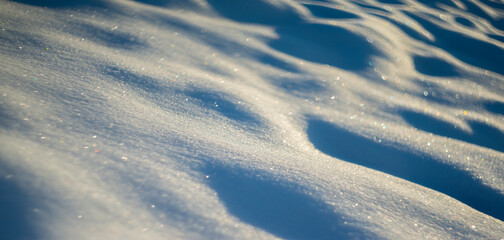 winter snow background - snow covered surface and artistic bokeh
