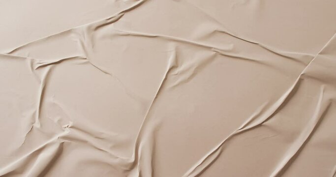 Video of close up of beige creased fabric with copy space