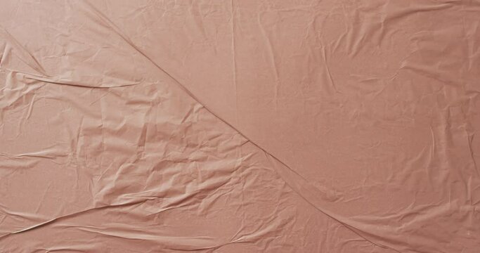 Video of close up of beige creased fabric with copy space