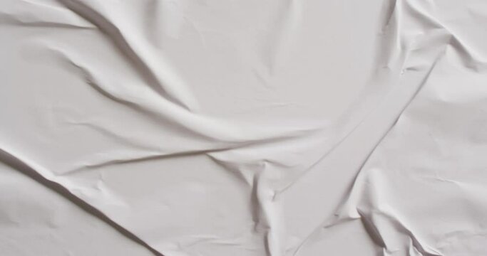 Video of close up of white creased fabric with copy space