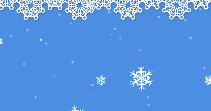 Image of snow falling over christmas decorations on blue background