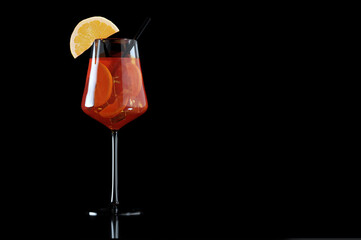 Glass of Spritz cocktail isolated on black background