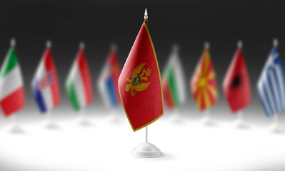 The national flag of the Montenegro on the background of flags of other countries