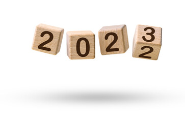 Happy new year concept. Wooden cube blocks changing from New year 2022 to 2023 flying over white