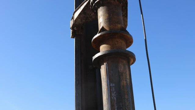 Rotary drilling rig machine's top part steel string pull auger's rod up from deep foundation hole