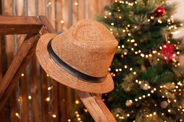 straw hat on a wooden hanger on a festive Christmas background