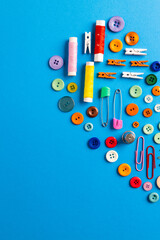 Fototapeta premium Composition of sewing equipment on blue background