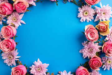 Fototapeta na wymiar Composition of rose wreath on blue background
