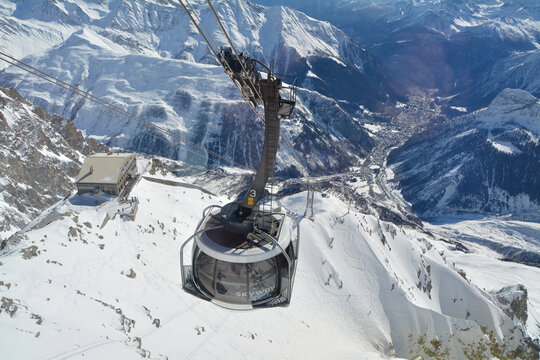 Alpine cable car Skyway Monte Bianco from Courmayeur to Punta Helbronner with scenic views of Mont Blanc massif and Alps.