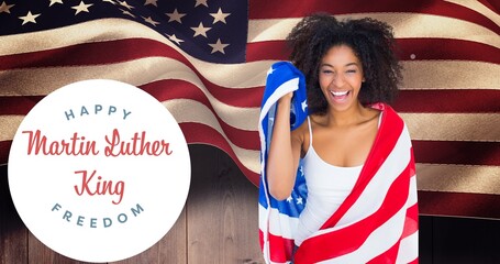 Portrait of smiling african american woman wrapped in usa flag by martin luther king jr day