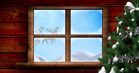Image of santa claus in sleigh with reindeer seen seen through window